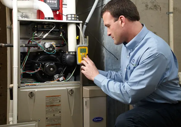 certified Legit Air technician diagnosing and repairing a modern furnace in a Whittier, California home basement