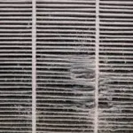 Clogged dirty furnace air filter full of dust and debris in Fullerton CA home