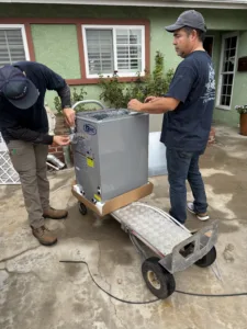 2 certified legit air hvac technicians prepping a new furnace in front of a Whittier ca home