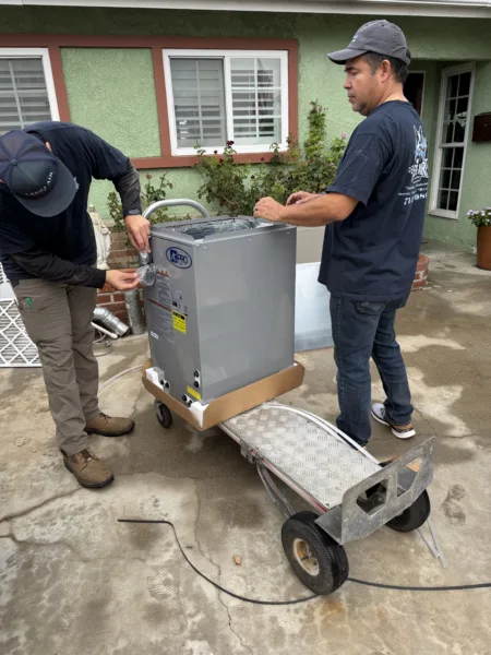 fullerton-legit-air-two-hvac-technicians-with-furnace 2 certified legit air hvac technicians prepping a new furnace in front of a Fullerton ca home